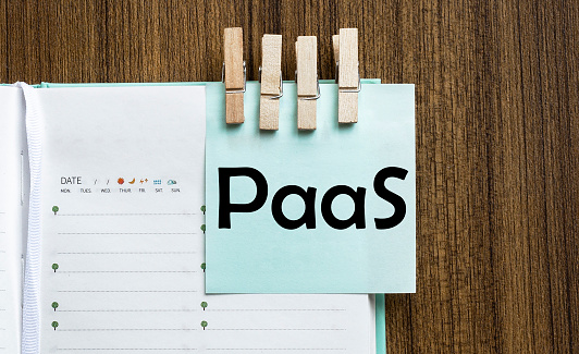 “PaaS” Colorful notes paper and a clothes pegs on wooden background
